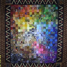 A mosaic art quilt with 2" squares arranged using the VIBGYOR sequence. Size:3x4 ft